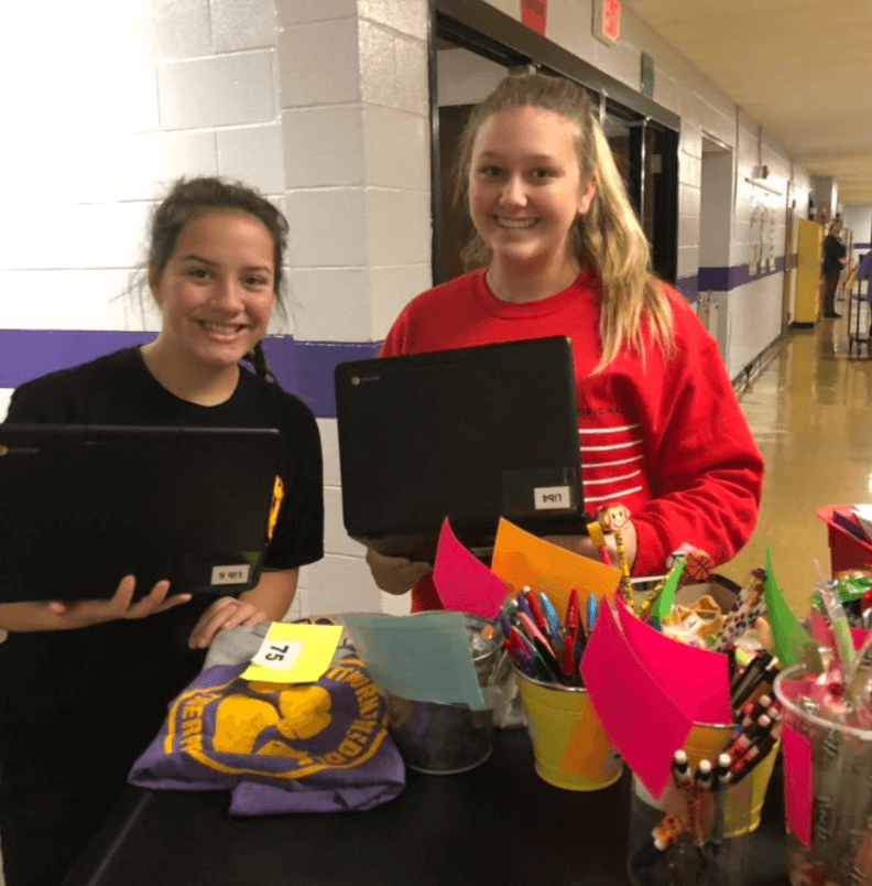 Two students shown with laptops running a School PBIS store