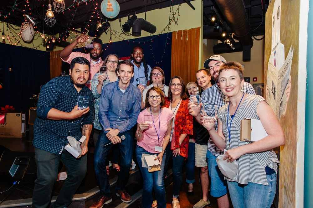 LiveSchool CEO joins a group of teachers holding trophies
